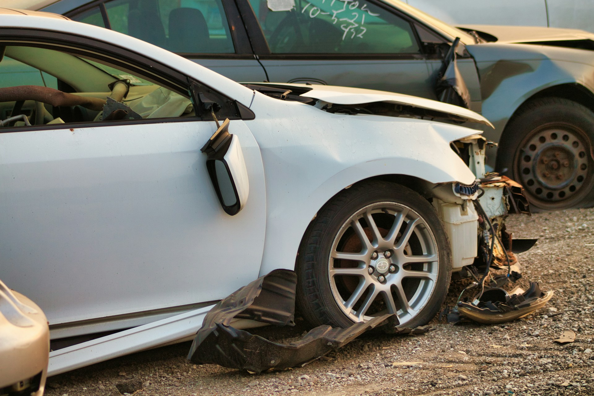 A car with a smashed up bumper