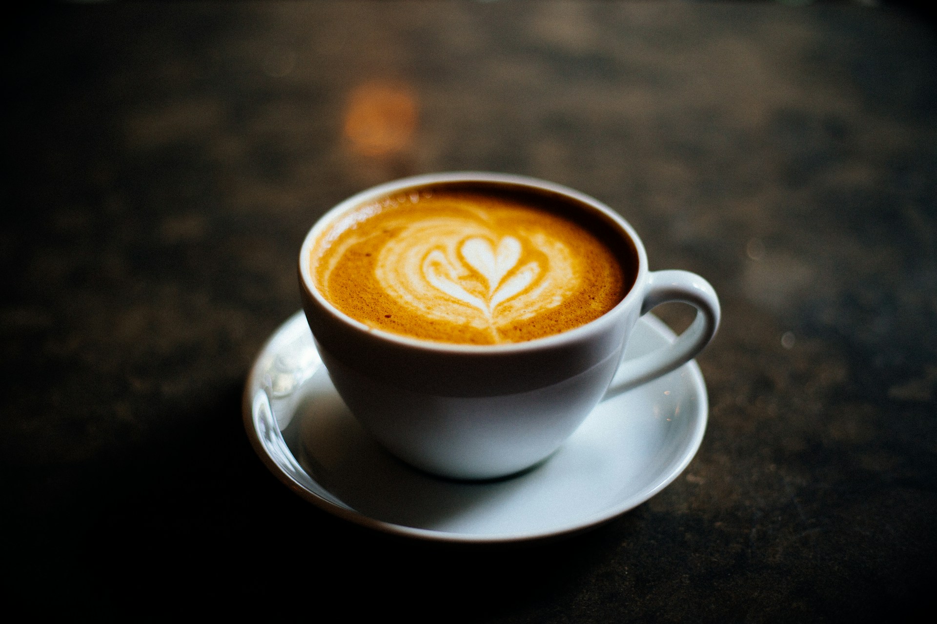 A cup of coffee with a heart in the foam