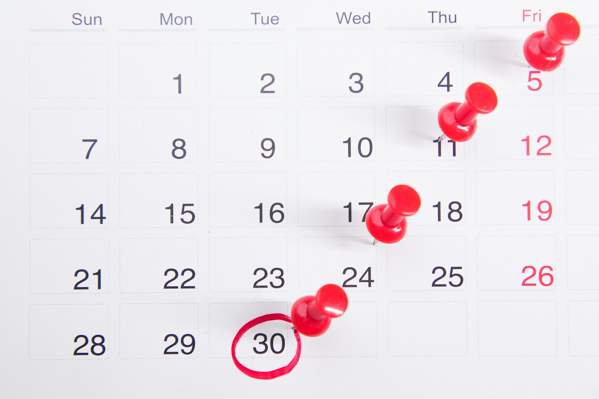 A calendar with pins to mark the days