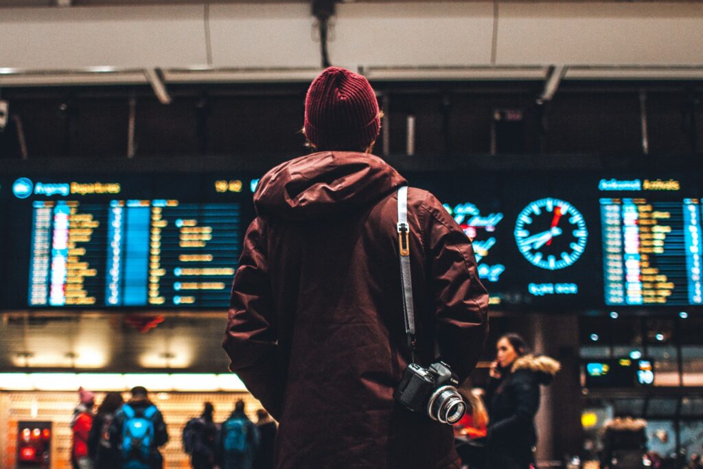 A person looking at an airport departure board